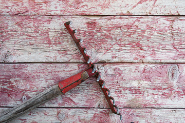 Garden rake on old boards background and worn paint