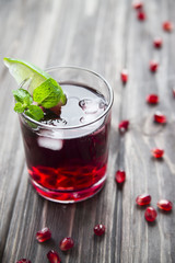 
Pomegranate cocktail with pomegranate seeds, lime and mint. alcoholic and non-alcoholic