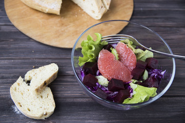 salad with grapefruit, red cabbage, beets and lettuce. bread