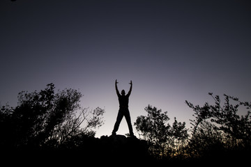 top of hill man silhouette