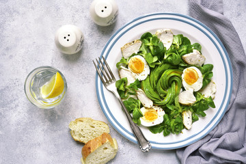 Green salad with chicken,avocado and eggs.Top view.