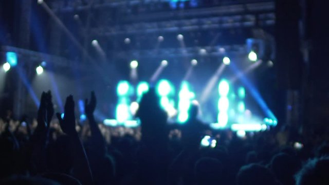 Hands of many excited people clapping in air, happy fans enjoying music concert