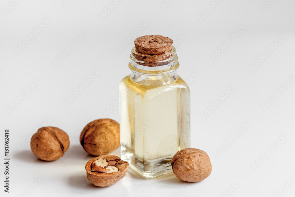 Wall mural cosmetic and therapeutic walnut oil on white background - Wall murals