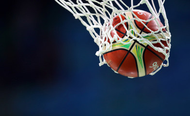 Basketball ball goes through the basket, net