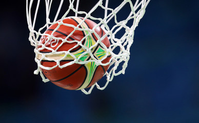 Fototapeta na wymiar Basketball ball goes through the basket, net