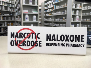 Naloxone sign showing pharmacy carries over the counter drug to prevent overdose
