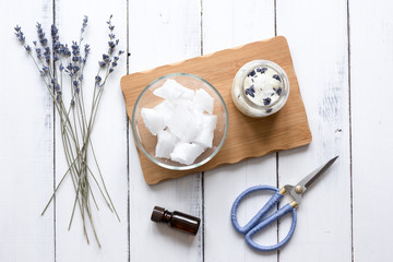 handmade candles with lavender on wooden background top view