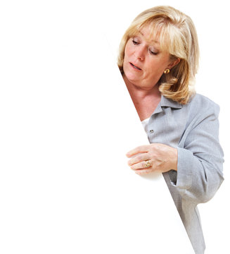 Mature Woman Looking At The Blank Sign She's Holding