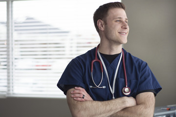 doctor looking out of window and smiling 