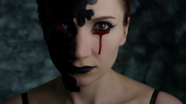 4k Shot of a Woman with Halloween Make-up with Bloody Tear Dropping
