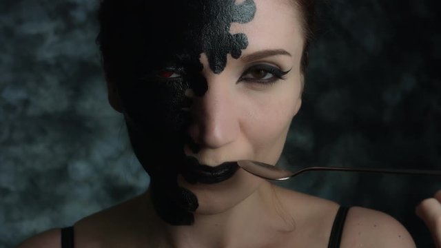4k Shot of a Woman with Halloween Make-up eating black Caviar