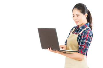 housewife with apron holding a computer