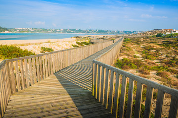 Fototapeta na wymiar Wooden walking path at the beach. Obidos Lagoon. Portugal