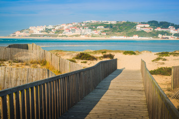 Wooden walking path at the beach. Obidos Lagoon. Portugal