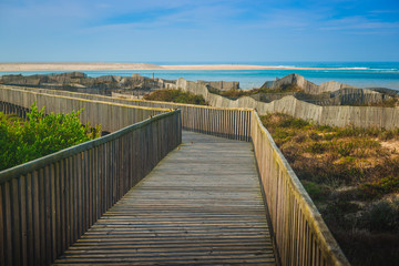 Fototapeta na wymiar Wooden walking path at the beach. Obidos Lagoon. Portugal