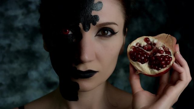 4k Shot of a Woman with Halloween Make-up with Pomegranate