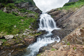Fototapeta na wymiar Mountain landscape of Kamchatka: beautiful waterfall