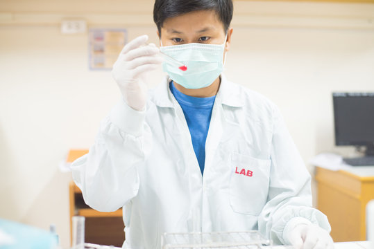asia scientist working in biological laboratory.