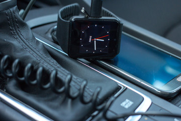 Modern car interior with smart watch on gear stick.
