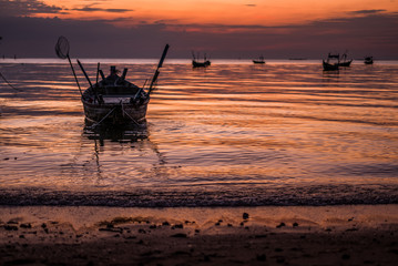 Fototapeta na wymiar Beautiful sunset with fishing boat, vintage tone