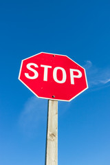 Red Stop Sign Against Blue Sky