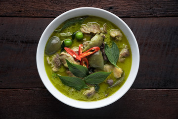 Thai food chicken green curry on dark wooden background. top view