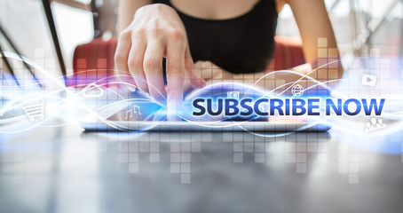 Woman using tablet pc and selecting subscribe now.