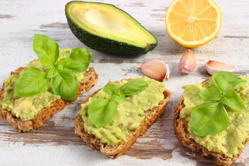 Freshly sandwiches with paste of avocado and ingredients, healthy food and nutrition