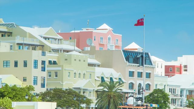The City of Hamilton in the British Overseas Territory of Bermuda on a Sunny Day, Featuring the Bermudan Architectural Style and Colors with a Flag and a Blue Sky Background