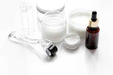 concept beautician desktop with mezoroller - mesotherapy on white background