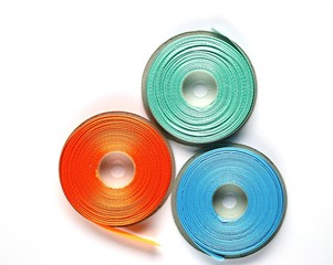 orange, blue, green satin ribbon on a white background