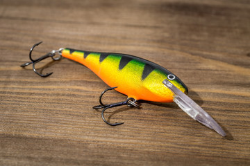 Spoon bait, lures, flies, tackle for catching or fishing a predatory fish on deck wood background