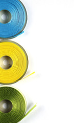 yellow, blue, green satin ribbon on a white background 1