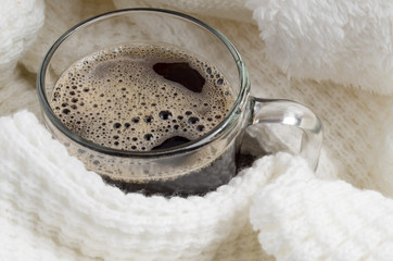Transparent glass mug with hot coffee closeup