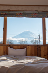 Bed with MT.Fuji view as background outside the window in winter