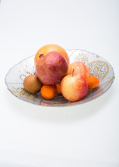 mix fresh fruits on plate isolated on white