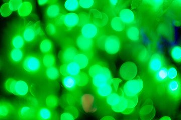 Obraz premium Bokeh light green defocus at night abstract background closeup.