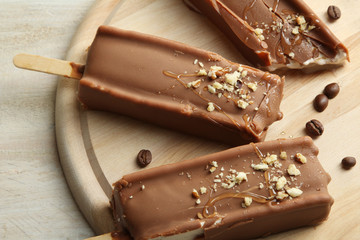 Classic chocolate ice cream with nuts on a wooden Boards.