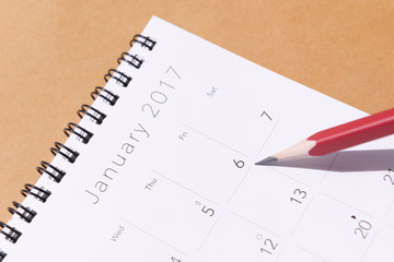 The 2017 new year calendar  on the brown background with the red pencil