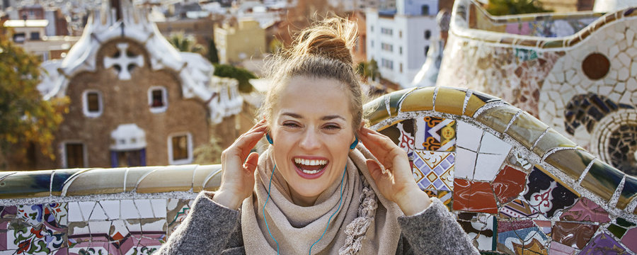 happy tourist woman in Barcelona, Spain sitting on bench