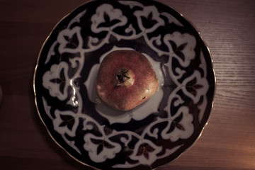 Pomegranate fruit on the uzbek plate