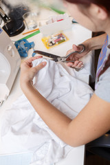 Fototapeta premium Woman cuts out with scissors