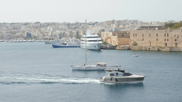 Bypass yachts in Valletta Bay Malta. In the city background.