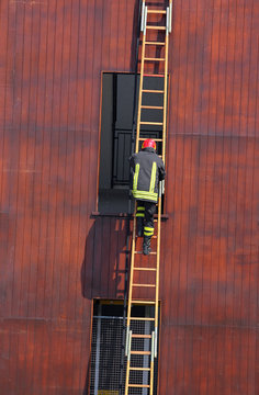 Chief Of The Fire Department As It Climbs Up The Ladder During A