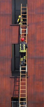 Fireman Climbs Up The Ladder During A Training Exercise