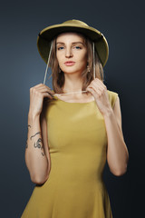 Portrait of arrogant lady in olive dress and cork colonial helme