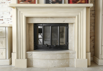 Modern beige fireplace in room