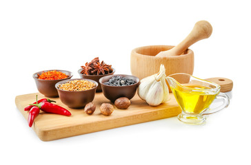 Composition with different spices and mortar on white background