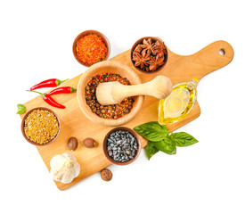 Composition with different spices and mortar on white background