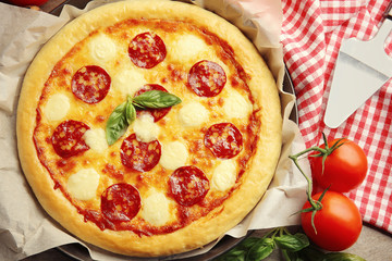 Homemade pepperoni pizza on wooden table